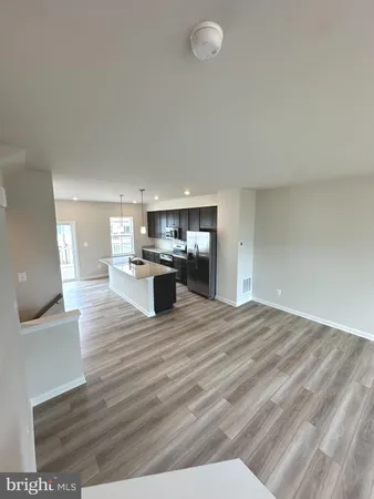 a view of kitchen living room with wooden floor
