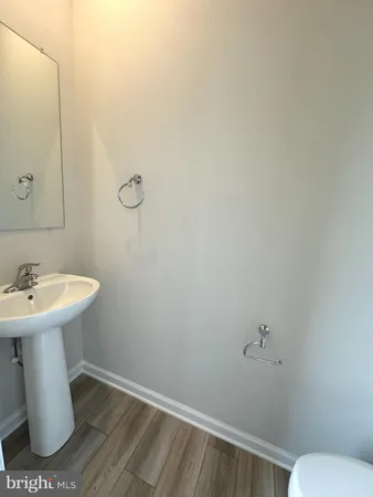 a bathroom with a sink a toilet and mirror