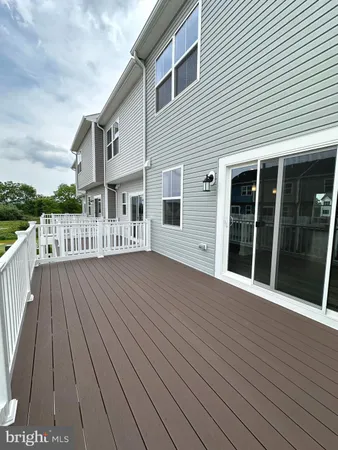 a view of a house with wooden deck