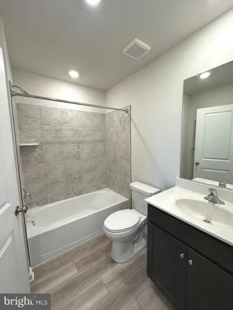 a bathroom with a sink a toilet and a bathtub