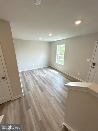 a view of room with window and wooden floor