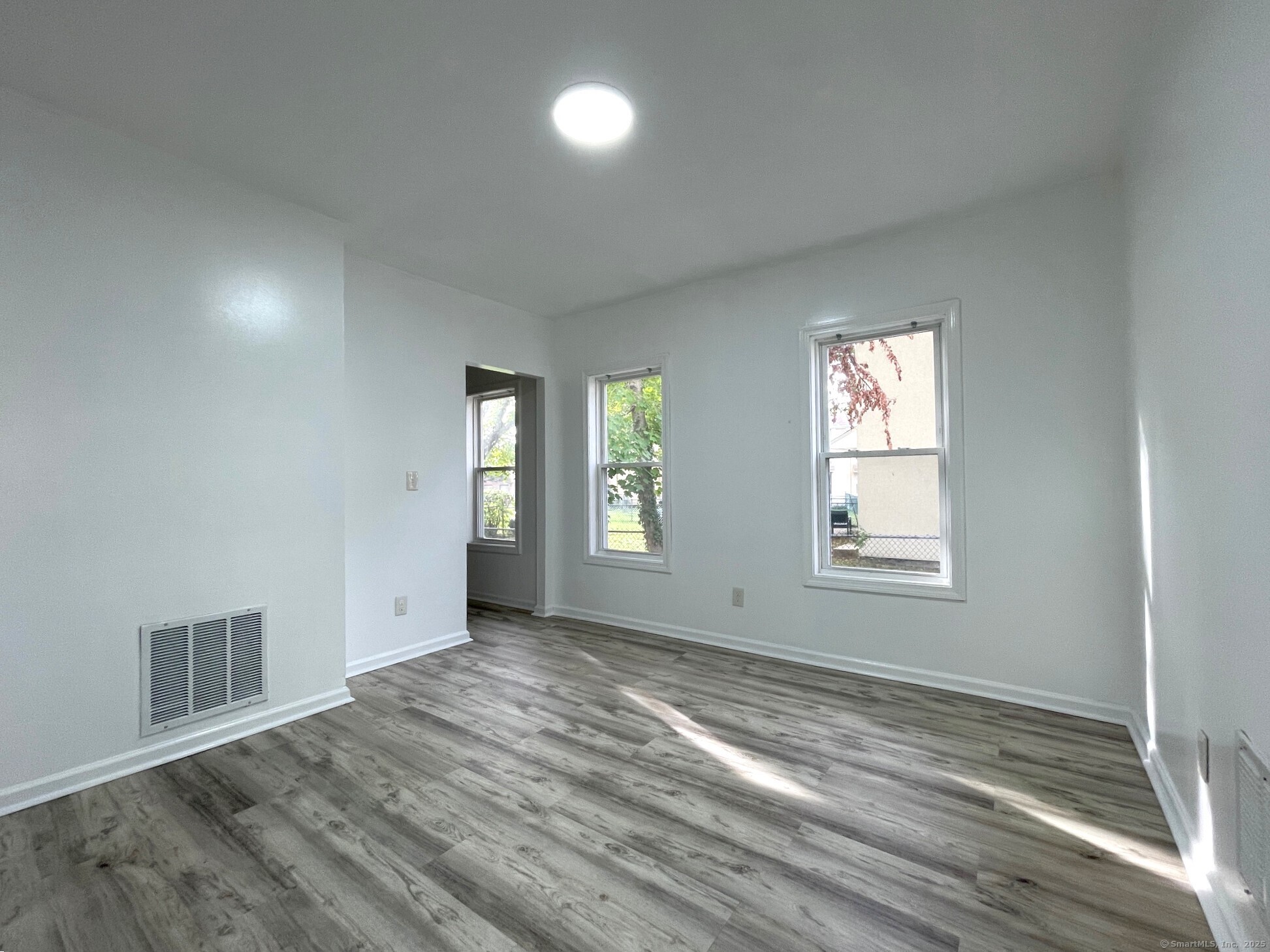 19 Townsend Street, Unit 1 New Haven, CT 06511 - Photo 4 of 8 a view of an empty room with wooden floor and a window
