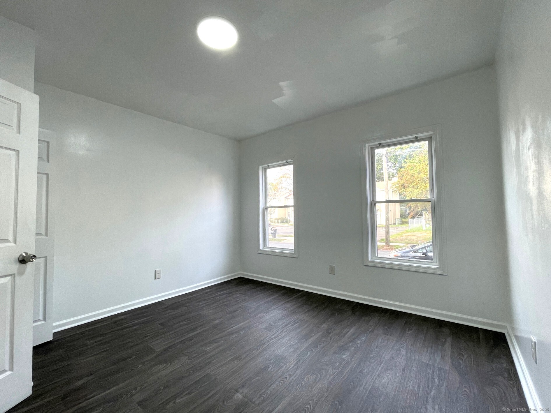 19 Townsend Street, Unit 1 New Haven, CT 06511 - Photo 7 of 8 an empty room with wooden floor and windows