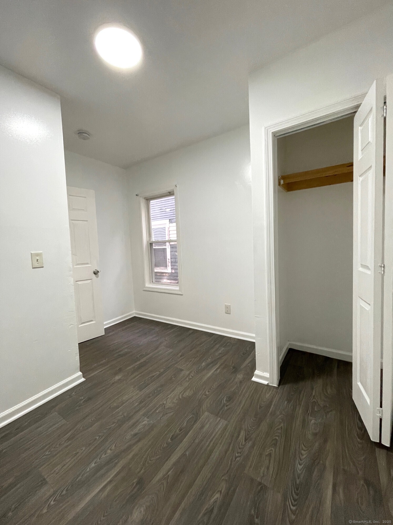 19 Townsend Street, Unit 1 New Haven, CT 06511 - Photo 8 of 8 an empty room with wooden floor and windows