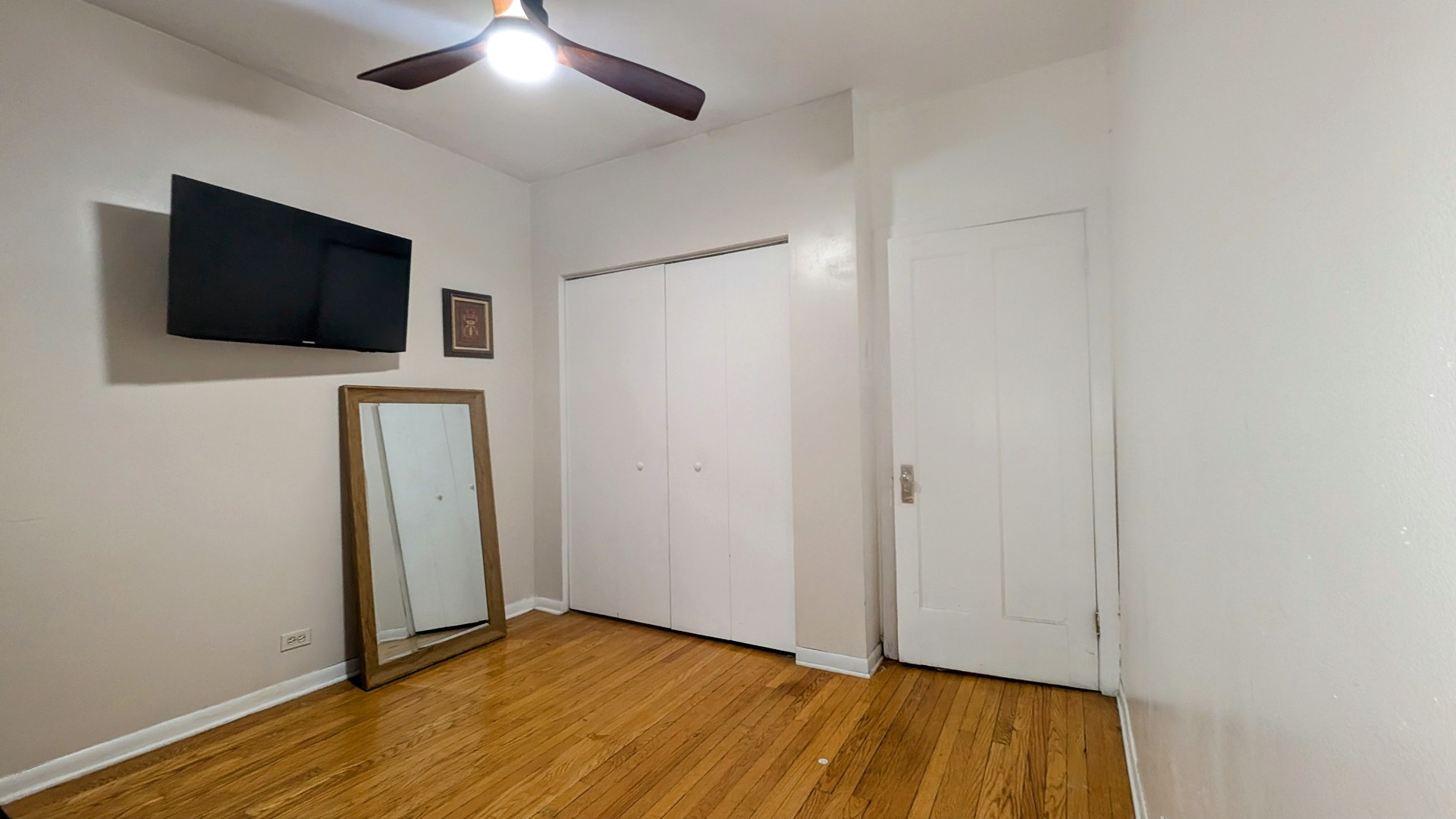 3707 West Cullom Avenue, Unit 1 Chicago, IL 60618 - Photo 12 of 16 a view of a livingroom with wooden floor and flat screen tv