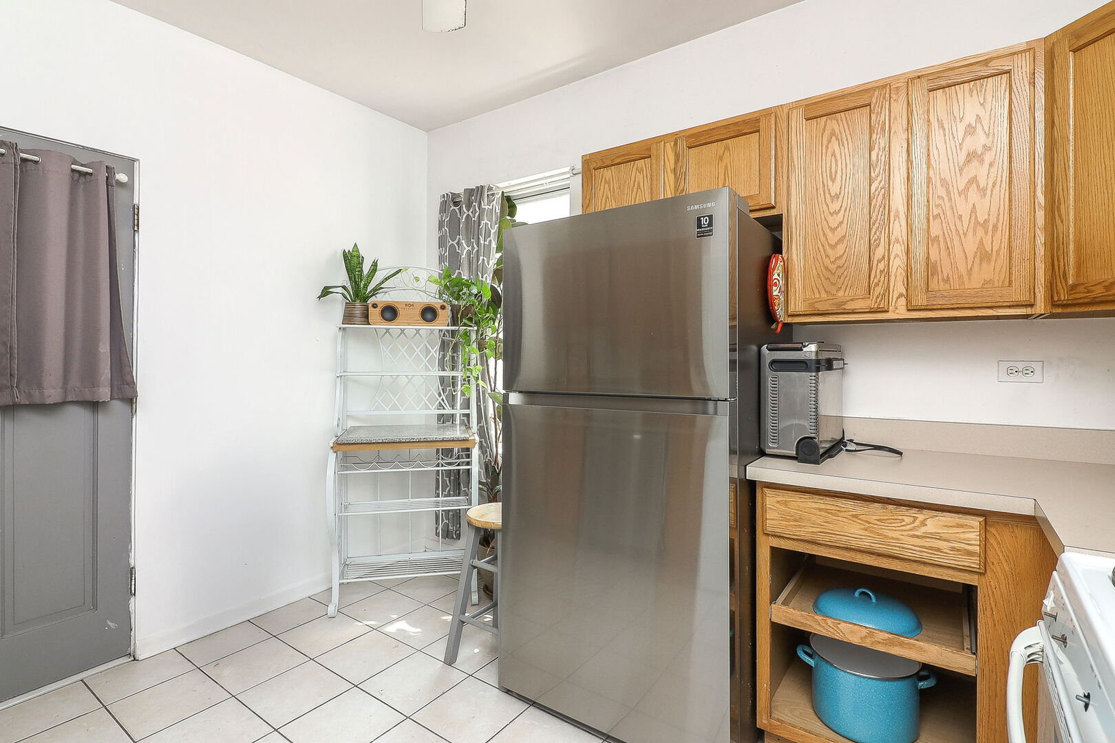 3707 West Cullom Avenue, Unit 1 Chicago, IL 60618 - Photo 8 of 16 a kitchen with stainless steel appliances granite countertop a refrigerator and a sink