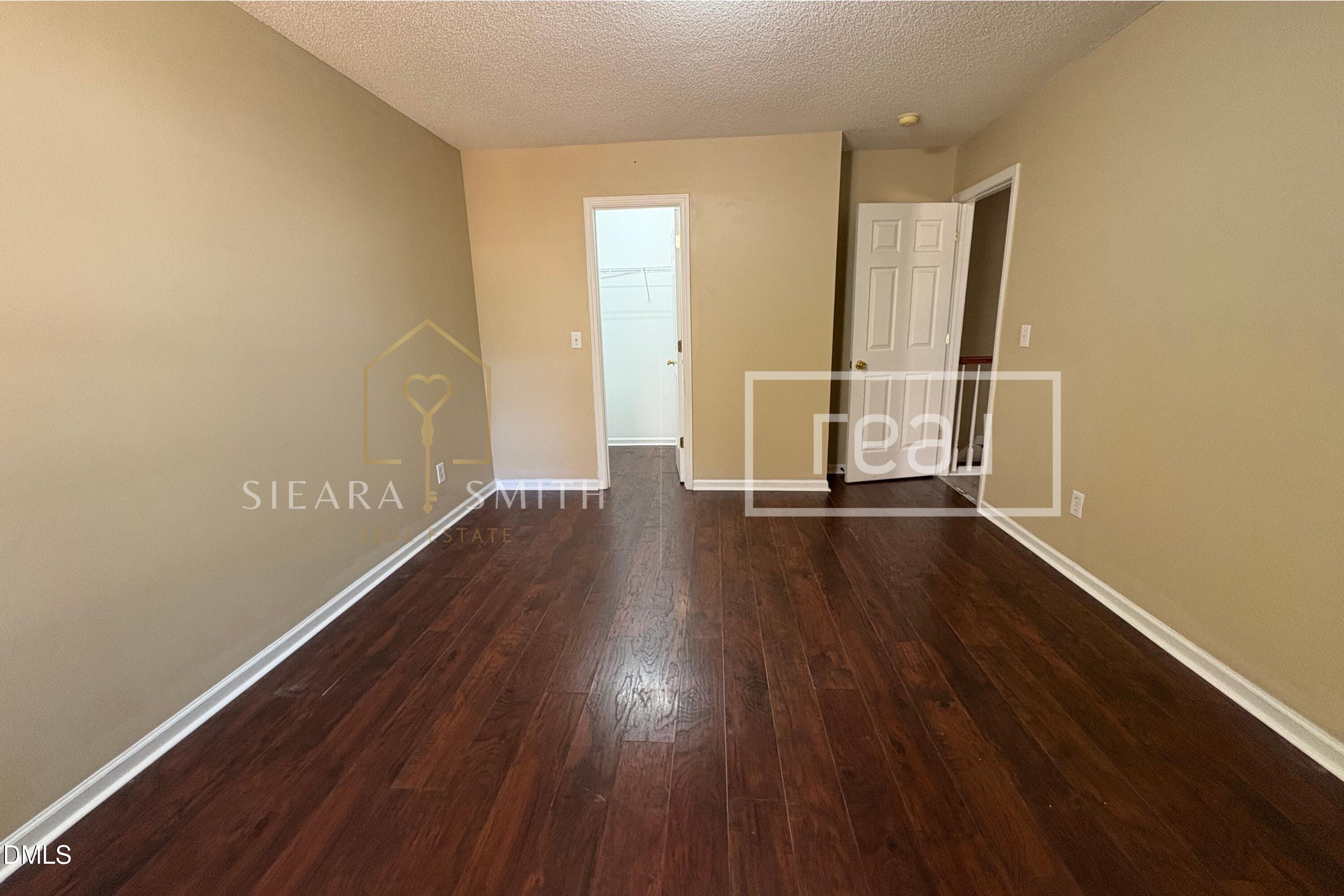6013 Silkwater Court Raleigh, NC 27610 - Photo 6 of 15 wooden floor in an empty room with a window