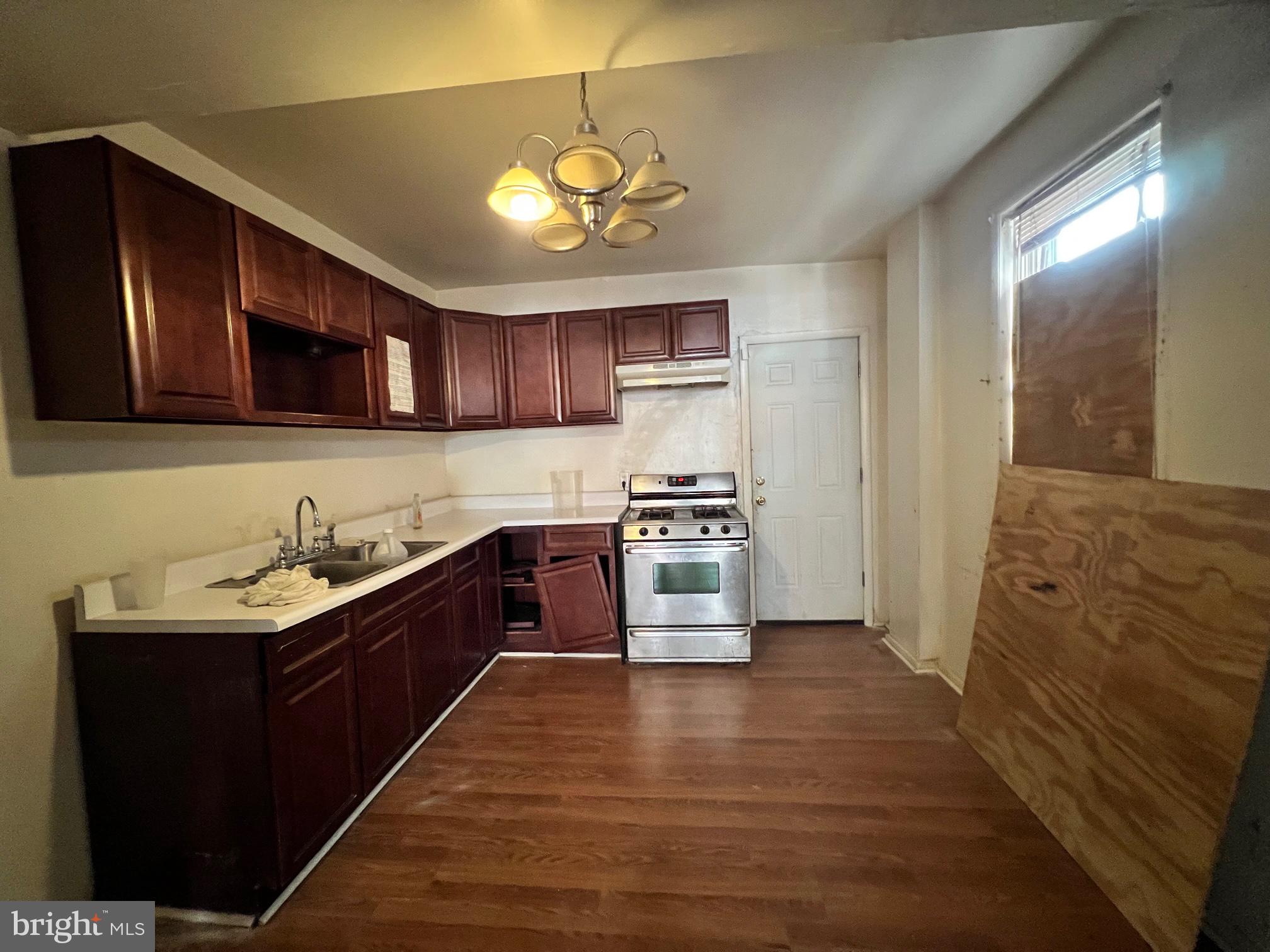 2516 West Seybert Street Philadelphia, PA 19121 - Photo 3 of 11 a kitchen with granite countertop a sink cabinets and stainless steel appliances