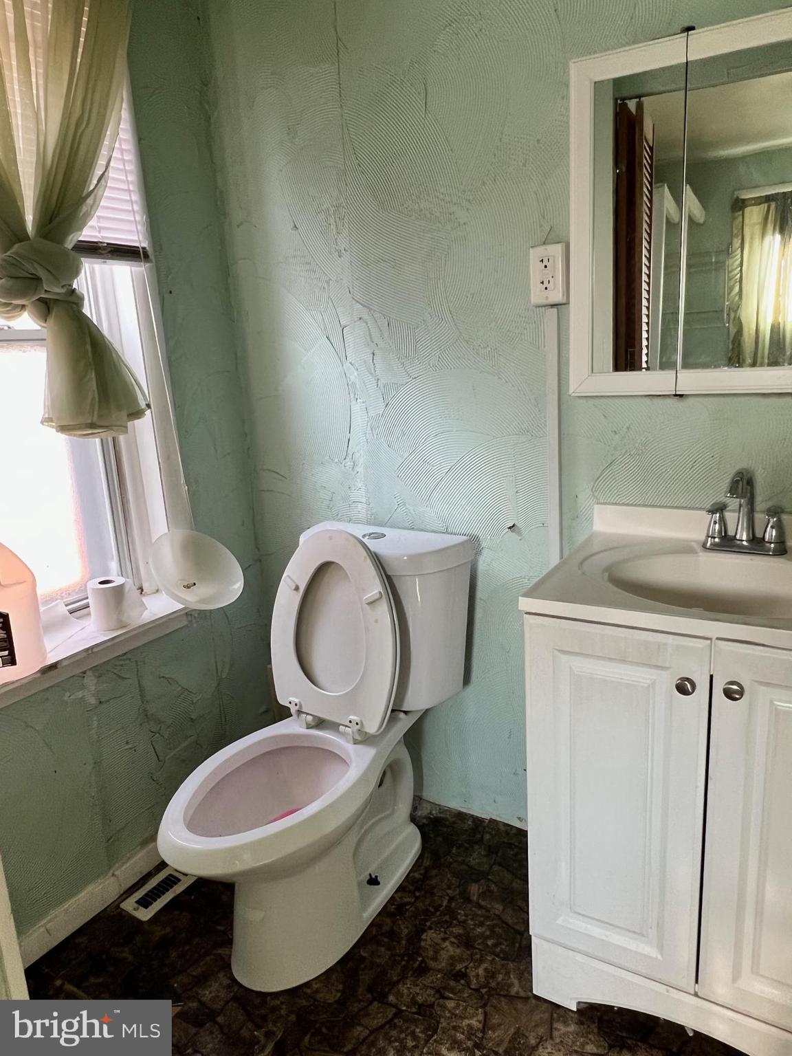 2516 West Seybert Street Philadelphia, PA 19121 - Photo 7 of 11 a white toilet sitting next to a bathroom sink