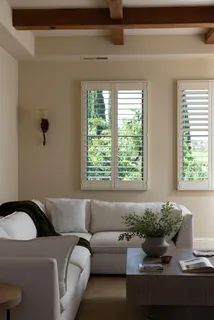 a living room with furniture and large windows