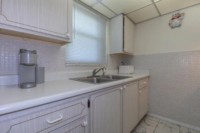 a kitchen with a sink and cabinets