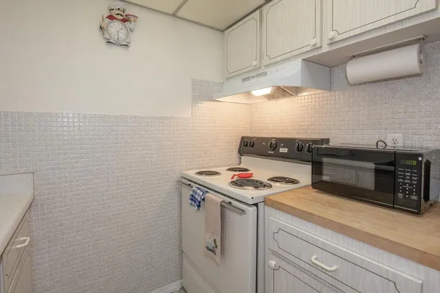a kitchen with a stove and cabinets