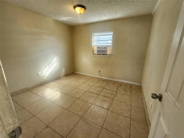 a view of an empty room and a window