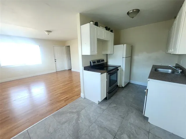 a kitchen with granite countertop a stove and a sink