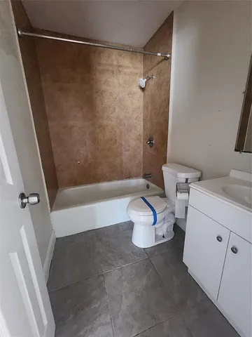 a bathroom with a bathtub and a toilet