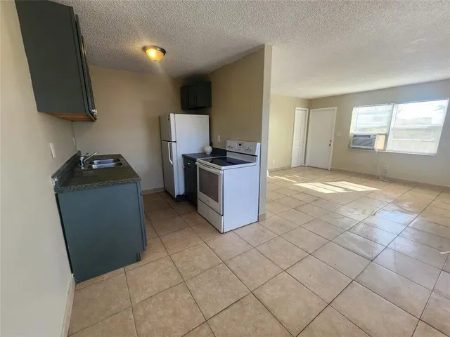 a kitchen with a sink and a stove top oven