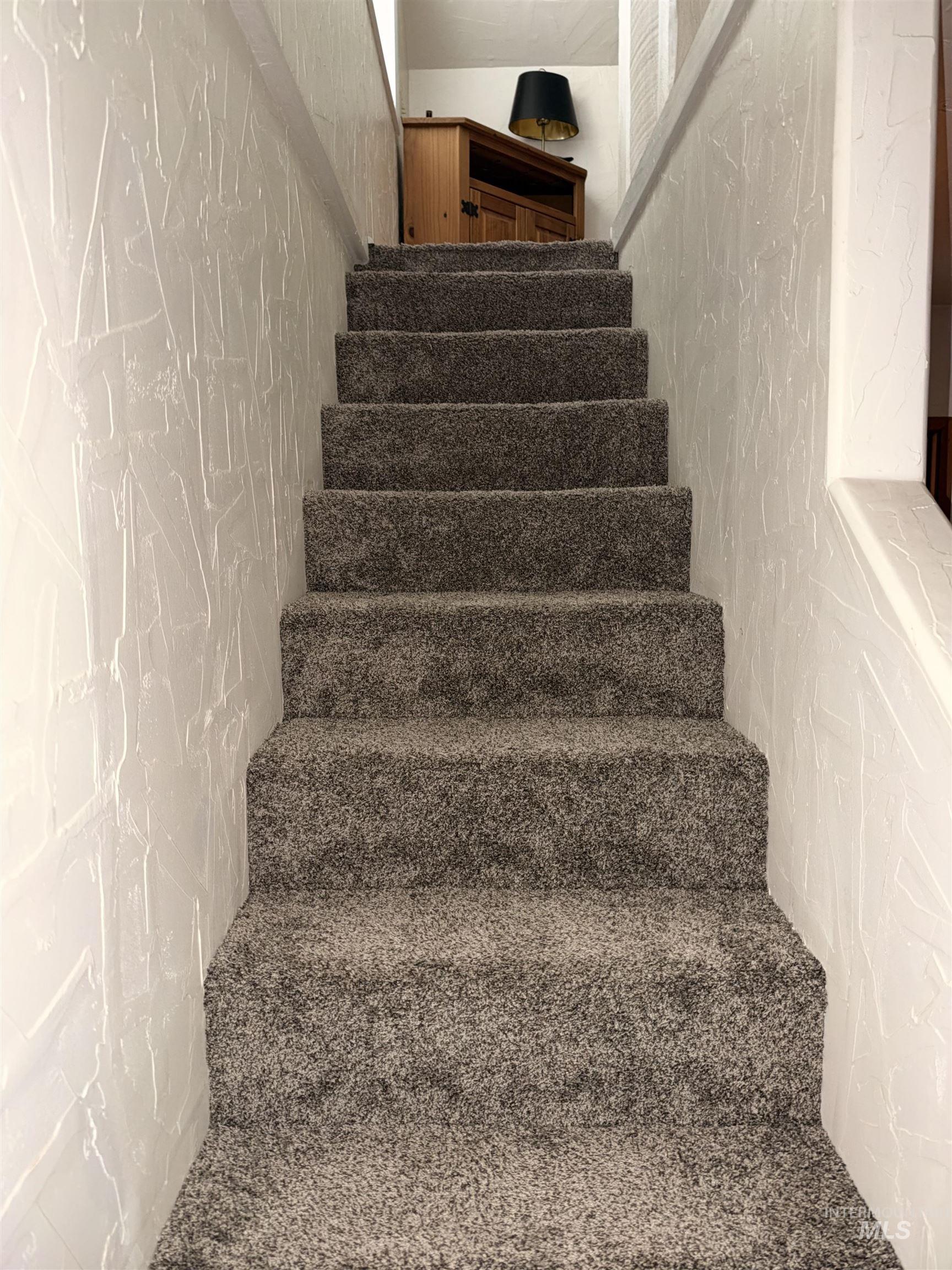 687 Big Cedar Road Kooskia, ID 83539 - Photo 27 of 37 Carpeted staircase with textured wall finish