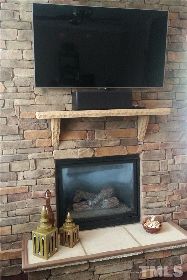 10131 Lynnberry Place Raleigh, NC 27617 - Photo 13 of 25 Beautiful stacked stone fireplace w/raised hearth is a family room focal point. Gas logs with easy flip on wall switch.