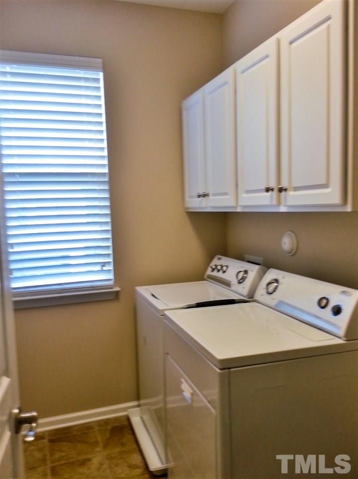 10131 Lynnberry Place Raleigh, NC 27617 - Photo 22 of 25 Second floor laundry room is conveniently located between bedrooms. Upper wall cabinets installed for linens and cleaning supplies.