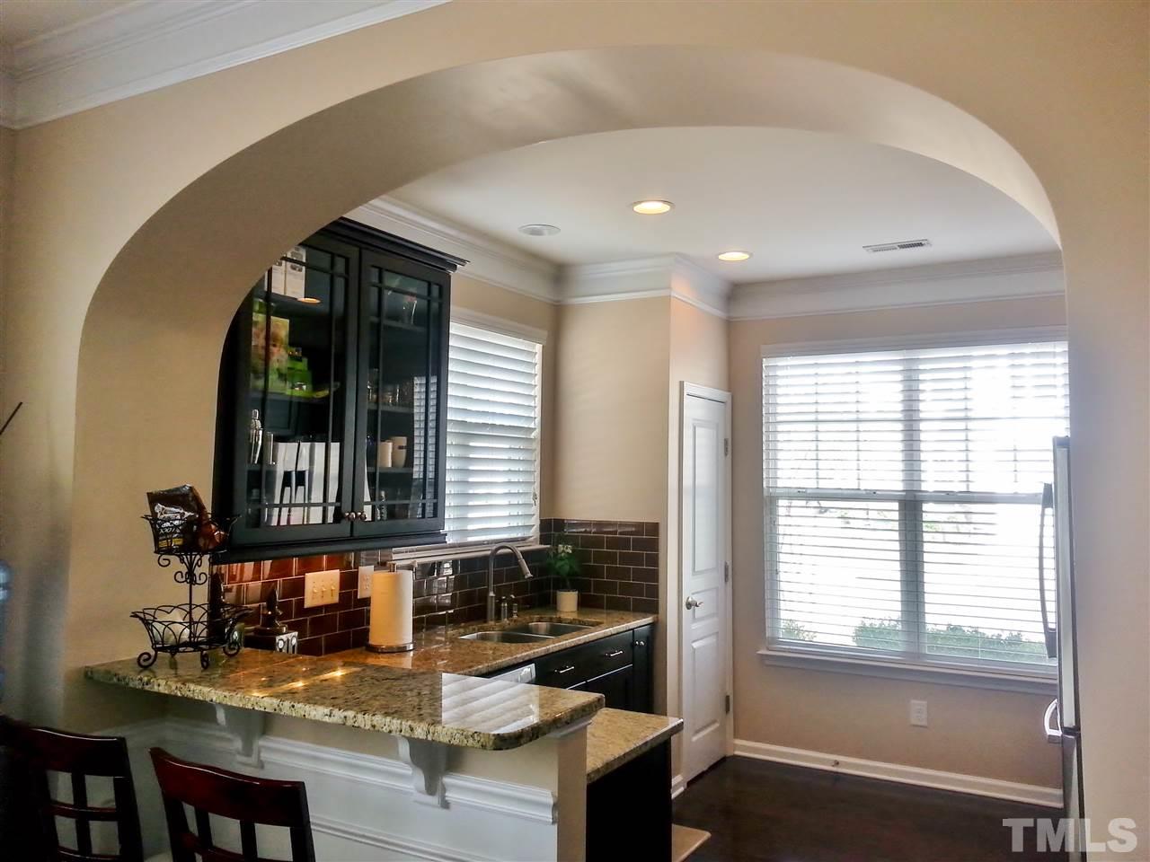10131 Lynnberry Place Raleigh, NC 27617 - Photo 7 of 25 Raised bartop between dining room and kitchen adds additional seating and countertop/entertaining space.