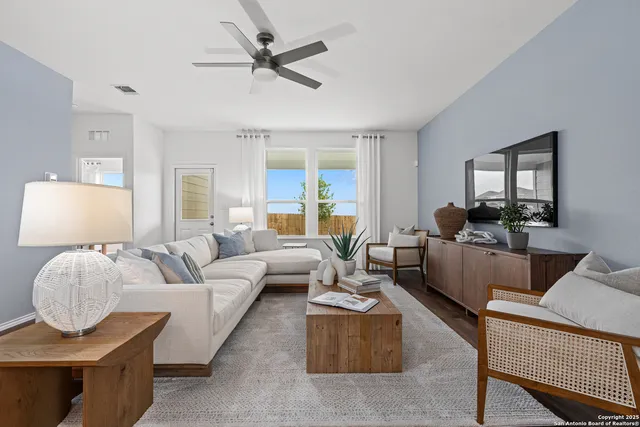 a living room with furniture and a large window