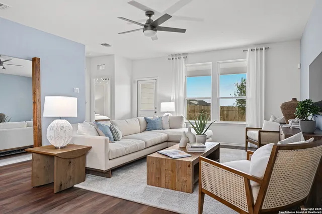 a living room with furniture and a large window