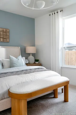 a bedroom with bed and window