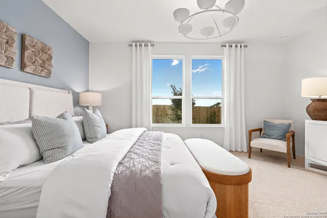 a bed room with a bed and a chair