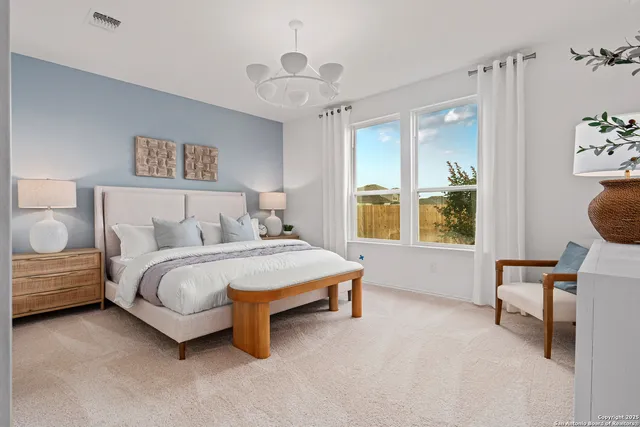 a spacious bedroom with a bed and a window