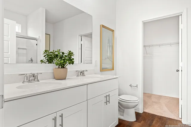 a bathroom with a sink a toilet and a mirror