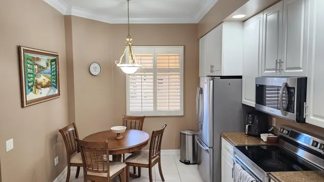 a kitchen with stainless steel appliances granite countertop a stove and a refrigerator