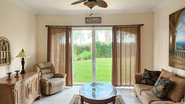 a living room with furniture and a floor to ceiling window