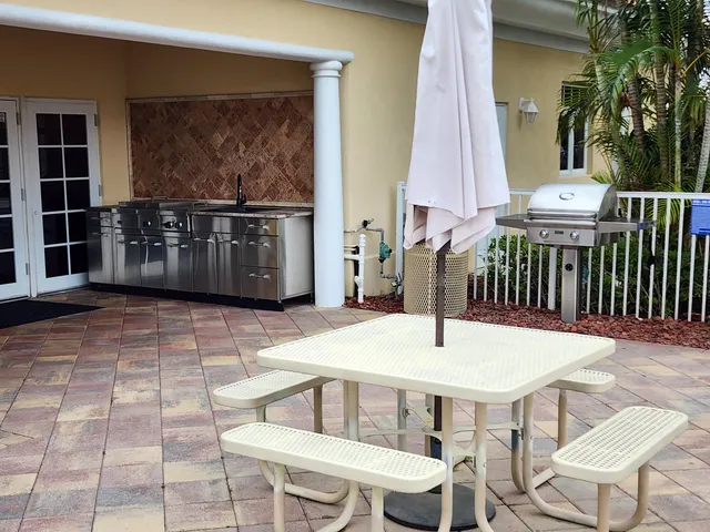 a dinning table and chairs in front of a house