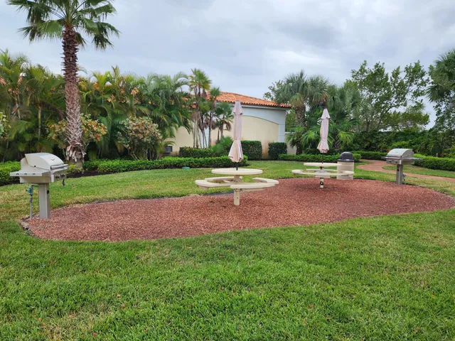 a view of a house with a yard and tree s