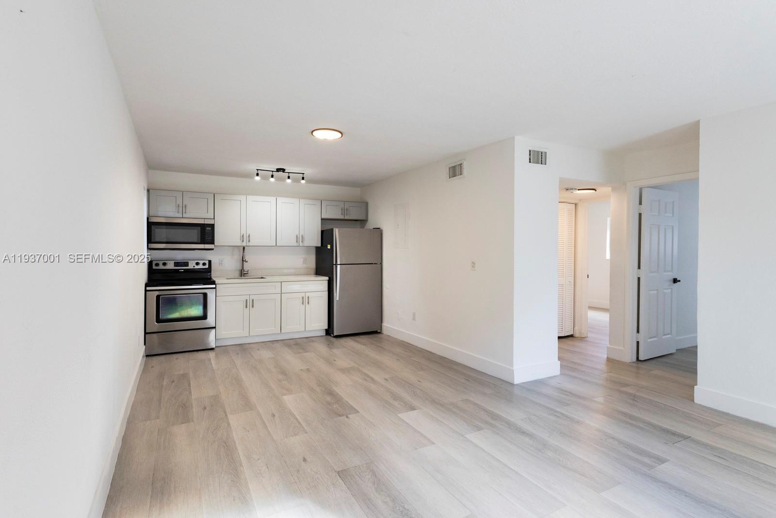 37 Northwest 59th Street, Unit 7 Miami, FL 33127 - Photo 6 of 15 a kitchen with stainless steel appliances a refrigerator and a oven