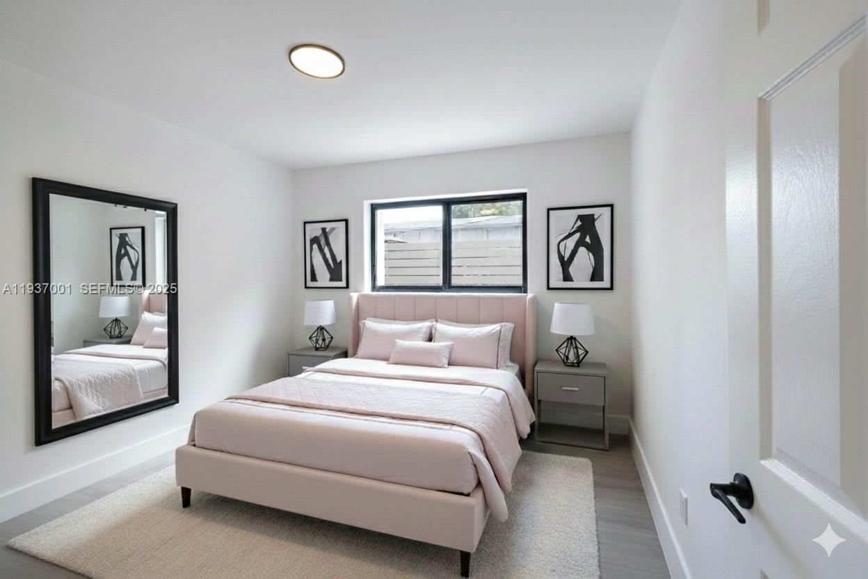 37 Northwest 59th Street, Unit 7 Miami, FL 33127 - Photo 8 of 15 a bedroom with a bed and a couch