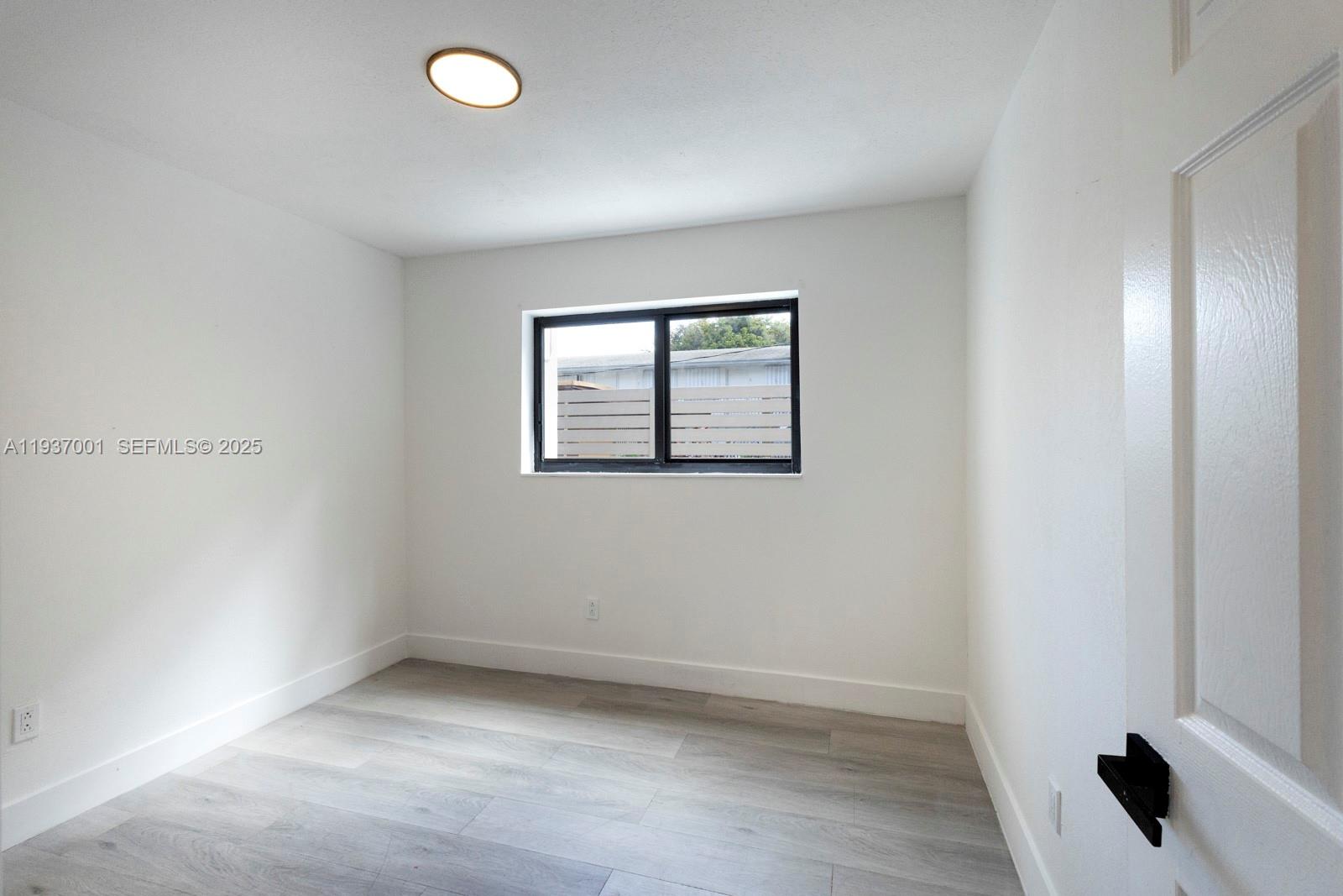 37 Northwest 59th Street, Unit 7 Miami, FL 33127 - Photo 9 of 15 an empty room with a window