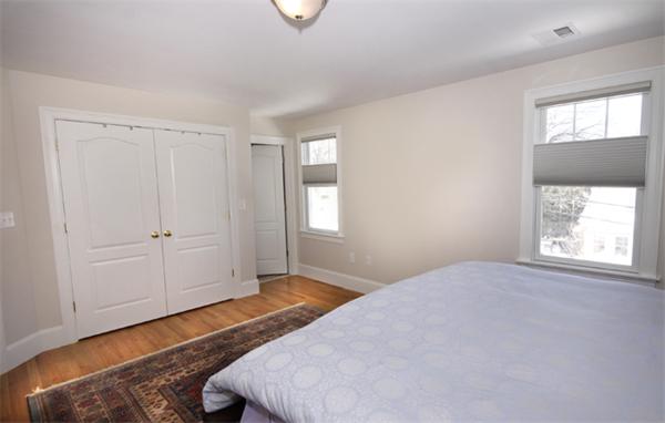 110 Robbins Road Arlington, MA 02476 - Photo 14 of 18 a bedroom with a bed and a window