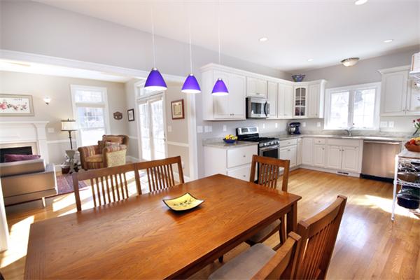 110 Robbins Road Arlington, MA 02476 - Photo 8 of 18 a kitchen with stainless steel appliances granite countertop a stove top oven a dining table and chairs with wooden floor