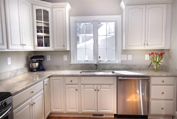 110 Robbins Road Arlington, MA 02476 - Photo 9 of 18 a kitchen with cabinets appliances a sink and a window