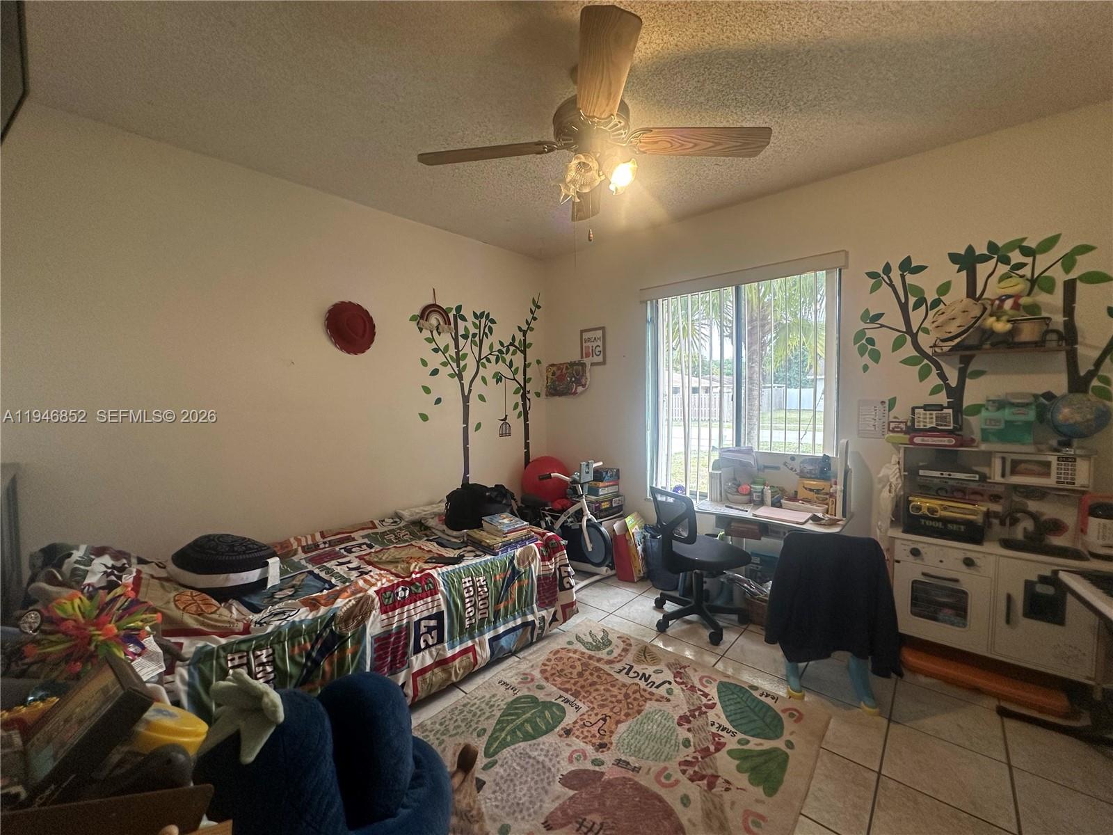 5965 Northwest 200th Street Hialeah, FL 33015 - Photo 11 of 23 a bed room with a bed a couch and a window