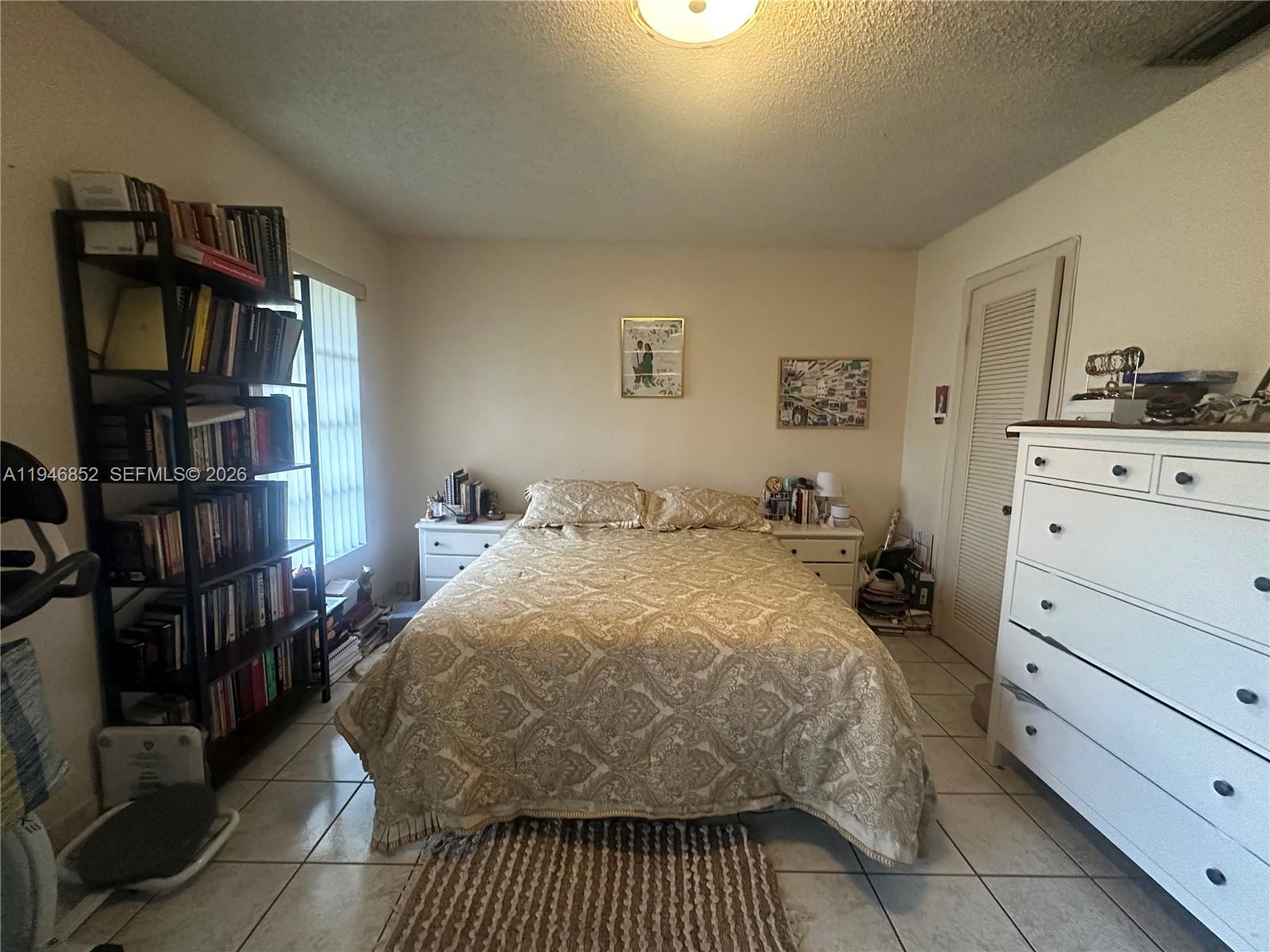 5965 Northwest 200th Street Hialeah, FL 33015 - Photo 13 of 23 a bedroom with a bed and closet