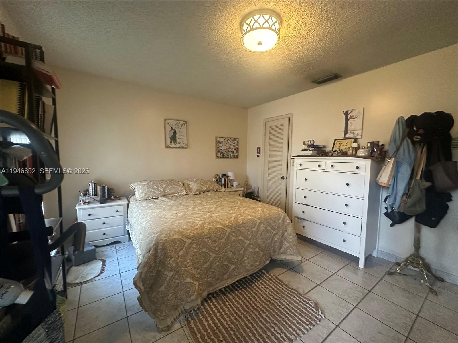 5965 Northwest 200th Street Hialeah, FL 33015 - Photo 14 of 23 a bed room with a bed and a television