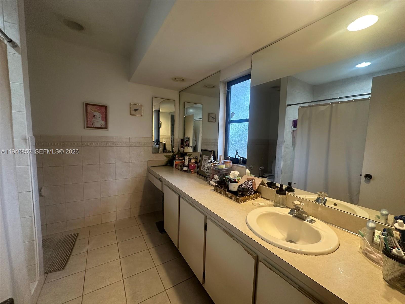 5965 Northwest 200th Street Hialeah, FL 33015 - Photo 15 of 23 a bathroom with a sink double vanity and a mirror