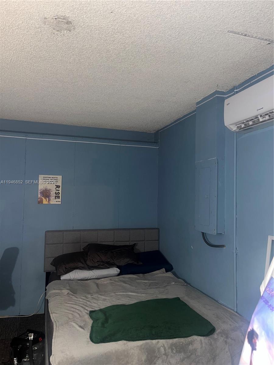 5965 Northwest 200th Street Hialeah, FL 33015 - Photo 19 of 23 a room with a bed and a potted plant