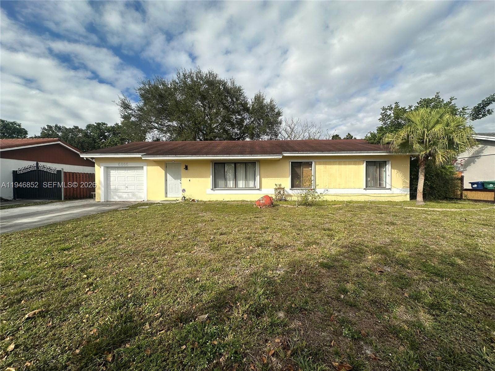 5965 Northwest 200th Street Hialeah, FL 33015 - Photo 23 of 23 a front view of a house with a garden