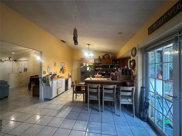 a bedroom with a bed and a view of living room