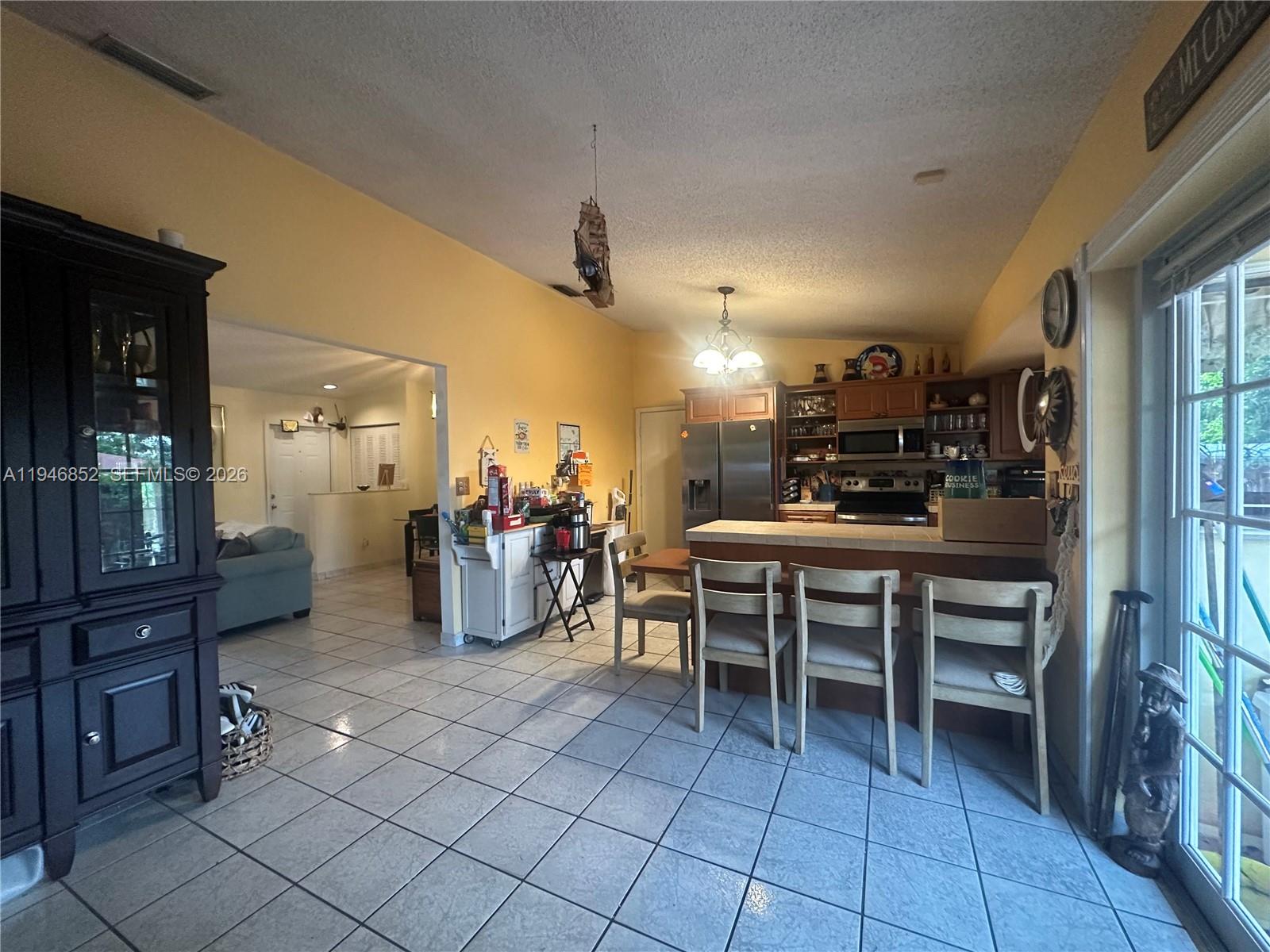 5965 Northwest 200th Street Hialeah, FL 33015 - Photo 9 of 23 a kitchen with lots of counter and chairs