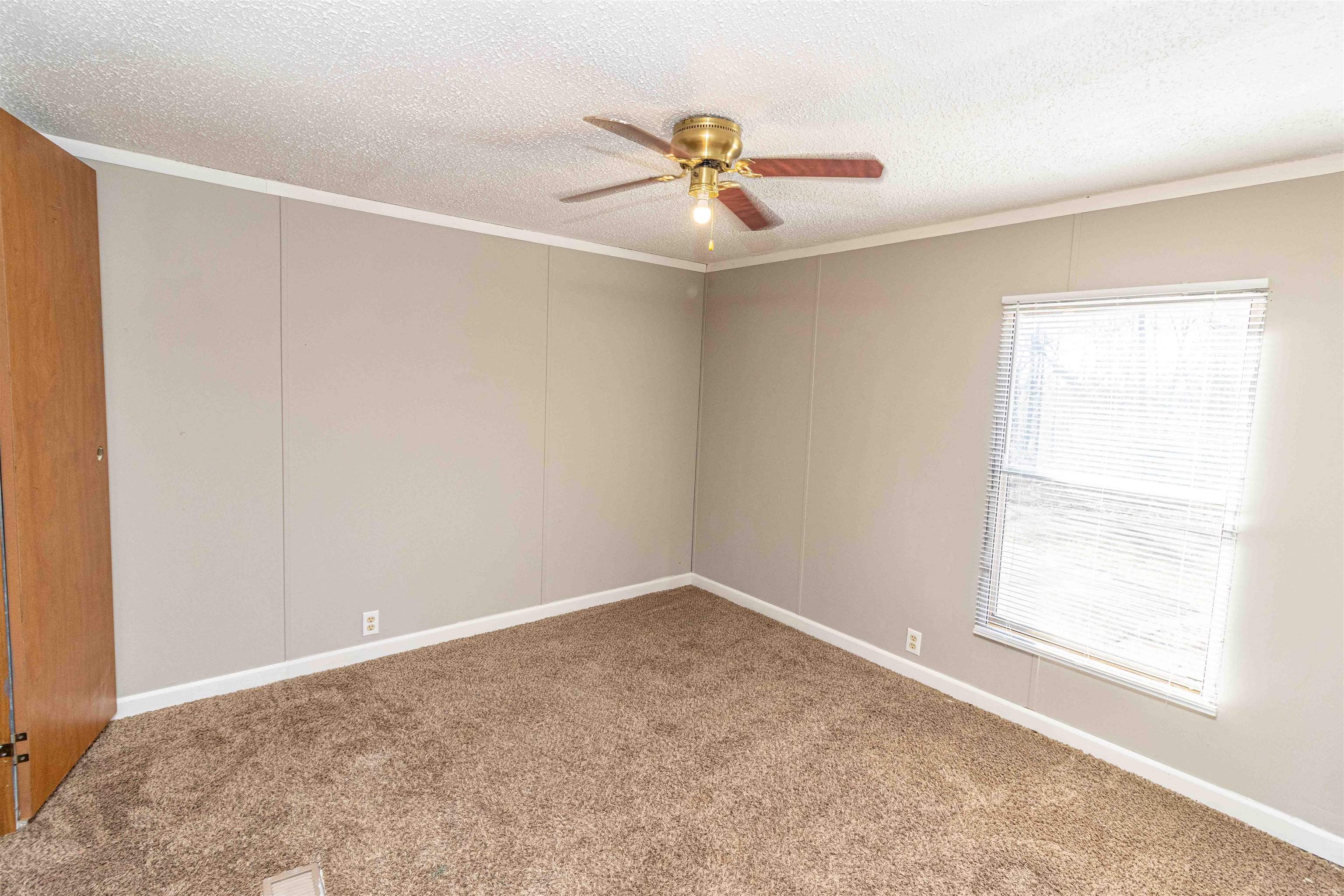 2419 Murray School Road Bethel Springs, TN 38315 - Photo 15 of 23 an empty room with a window and a ceiling fan