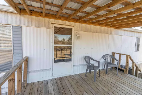 a view of a wooden chairs in a balcony